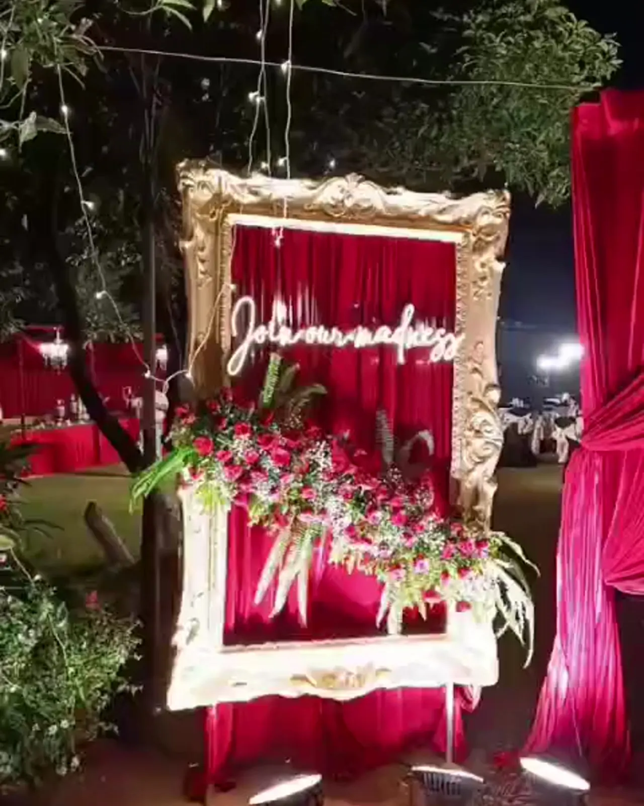 Oversized selfie frame with red drapes