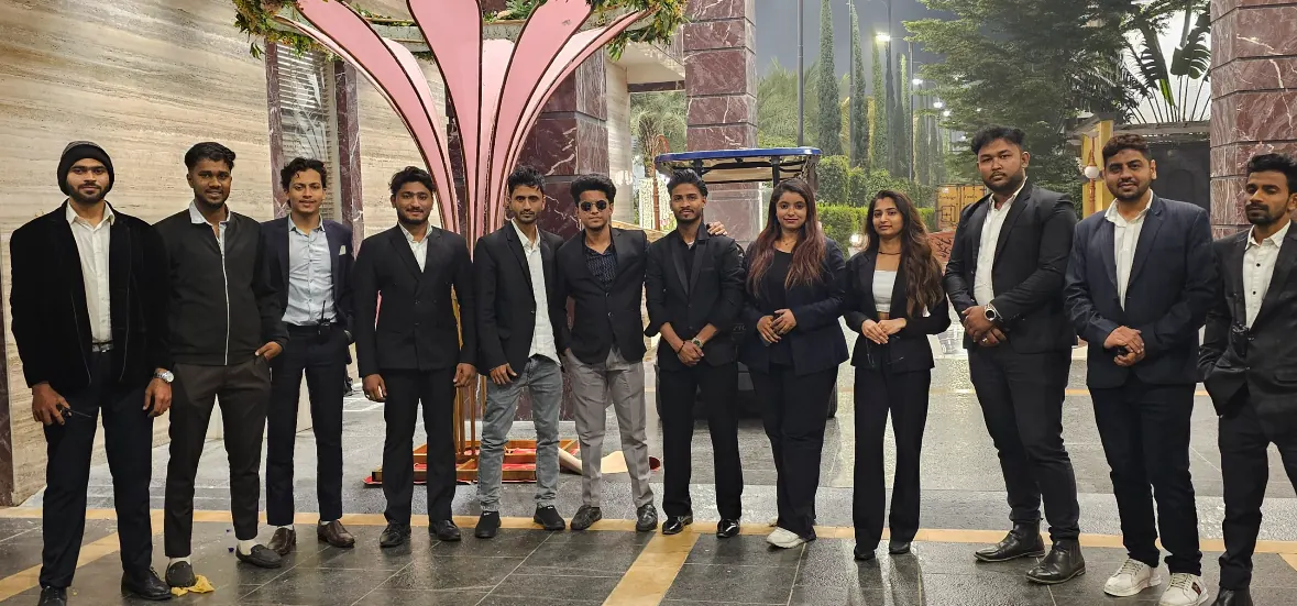 The PlanItBetter hospitality team in uniform at a hotel entrance
