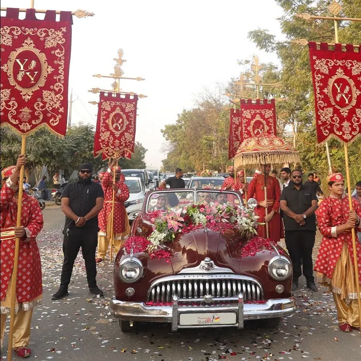 Vintage car wedding entry with the team