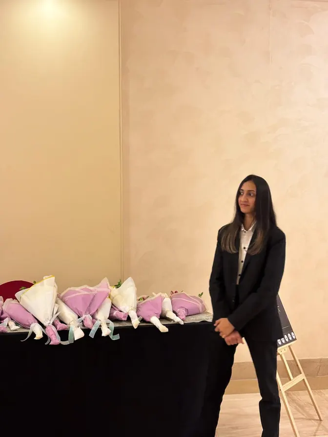 Host beside a table of welcome gifts