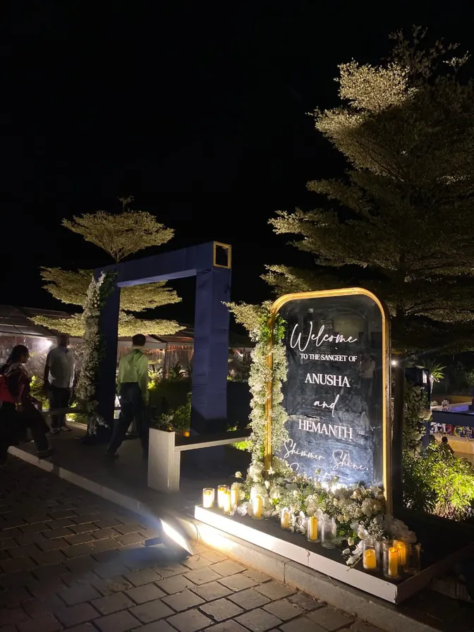 Welcome signage at a wedding venue entrance at night